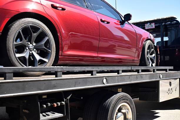 Professional tow truck operator completing vehicle recovery process in New Orleans
